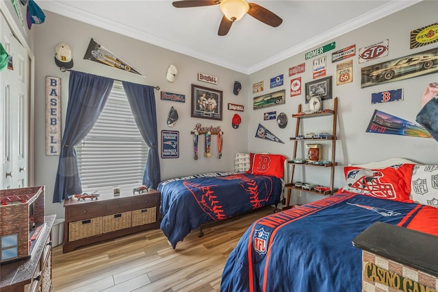 bedroom featuring crown molding, ceiling fan, and hardwood / wood-style floors