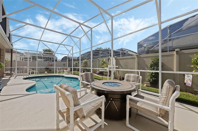 view of swimming pool featuring a lanai and a patio area