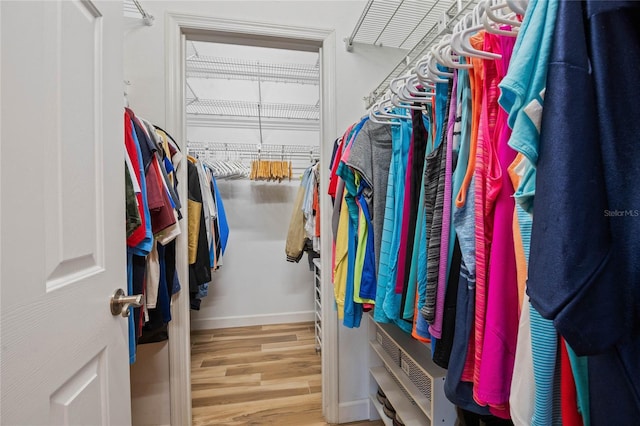 spacious closet featuring hardwood / wood-style floors