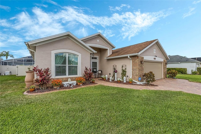 single story home with a garage and a front lawn