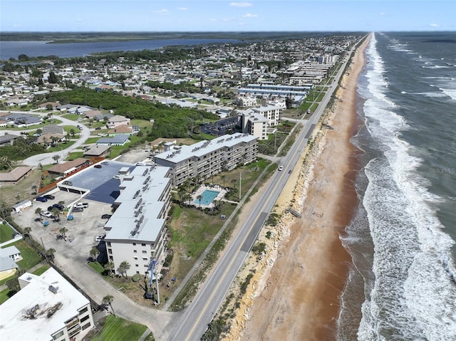 bird's eye view featuring a view of the beach and a water view