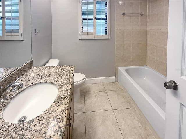 full bathroom with tile patterned floors, vanity, toilet, and a healthy amount of sunlight