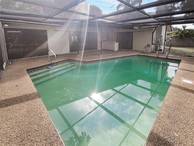 view of pool featuring a lanai and a patio