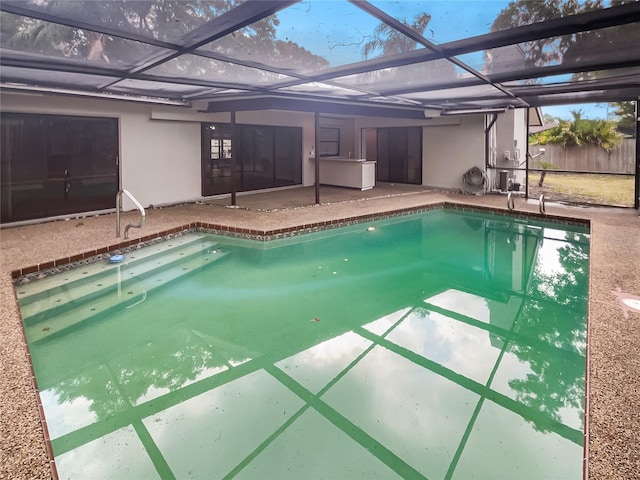 view of pool with a lanai and a patio area