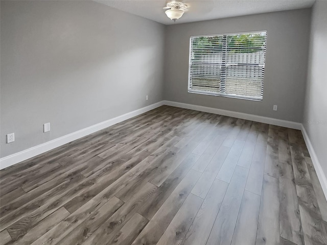 unfurnished room featuring hardwood / wood-style floors and ceiling fan