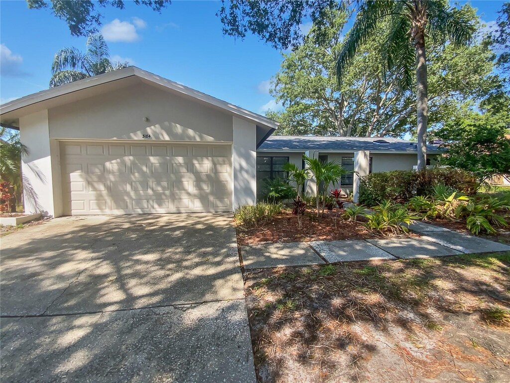 3184 Wessex Way, Clearwater, FL 33761 - single story home featuring concrete driveway, stucco siding, and an attached garage