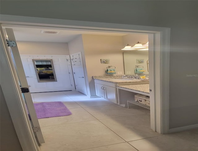 bathroom with tile patterned flooring and vanity