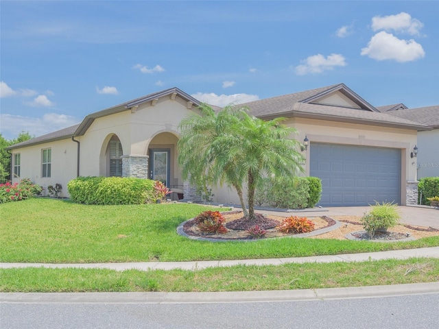 view of front of home with stucco siding, a front lawn, concrete driveway, and an attached garage