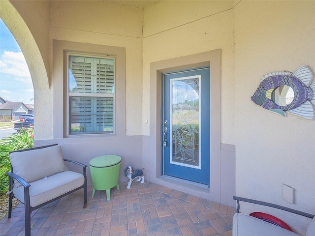 property entrance featuring stucco siding