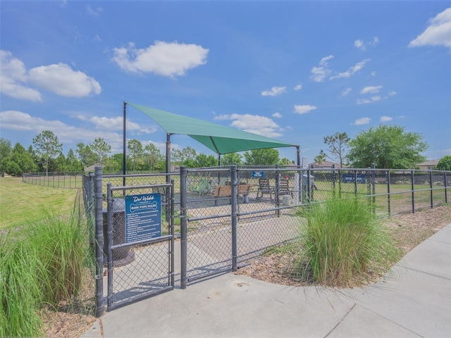 view of property's community featuring fence and a gate