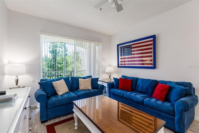 living room with light wood-type flooring and ceiling fan