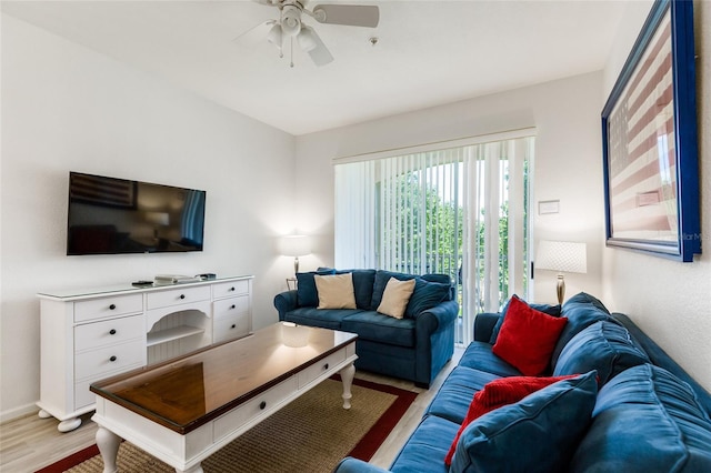 living room featuring ceiling fan and light hardwood / wood-style flooring