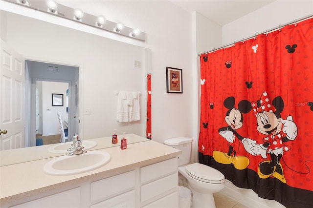 bathroom with tile flooring, oversized vanity, and toilet