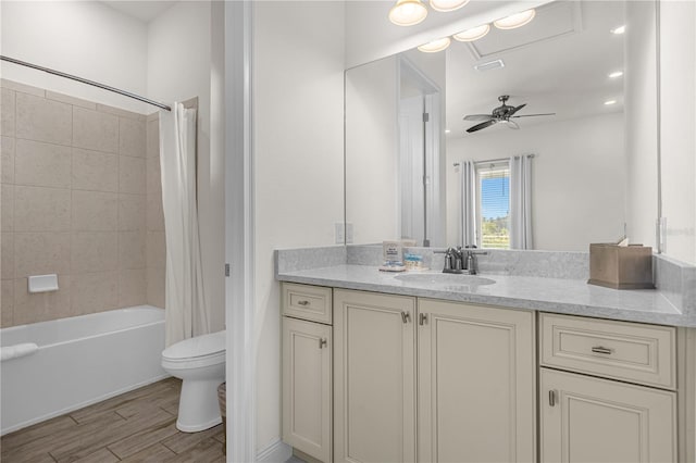 full bathroom with vanity, shower / bathtub combination with curtain, toilet, and ceiling fan