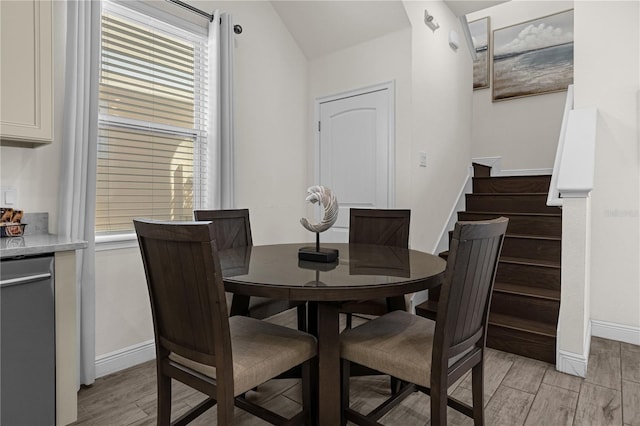 dining area featuring vaulted ceiling