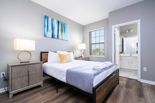 bedroom featuring sink, wood-type flooring, and connected bathroom