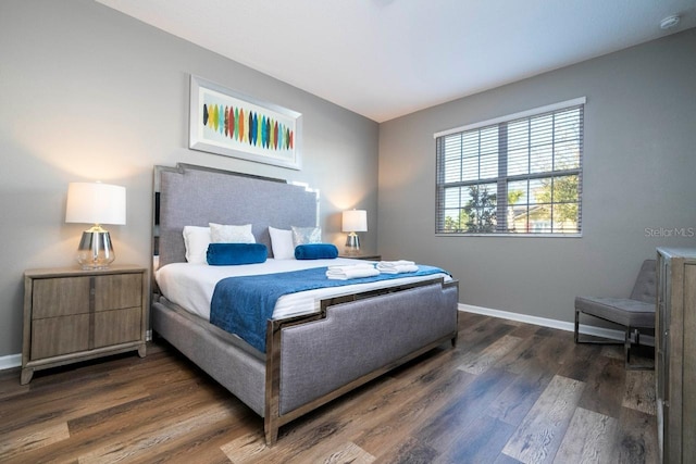 bedroom with dark wood-type flooring