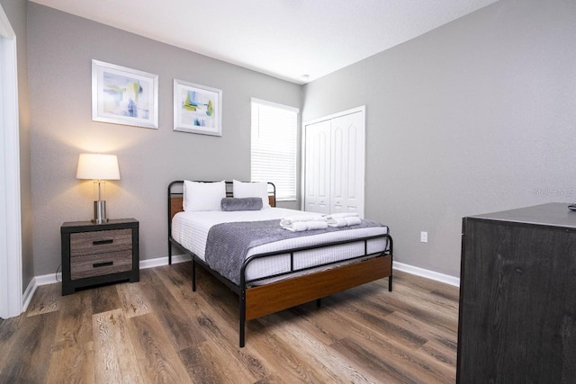 bedroom featuring dark hardwood / wood-style floors and a closet