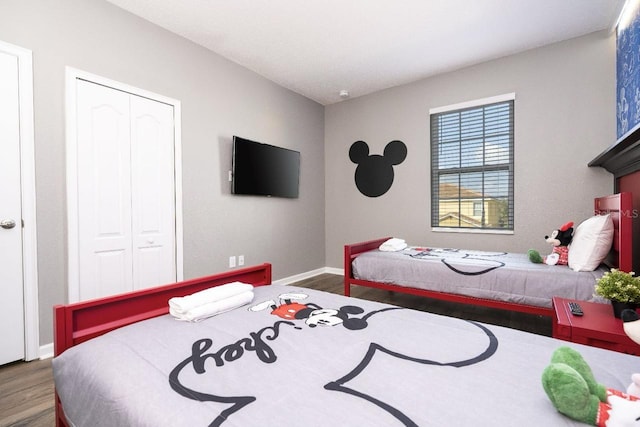 bedroom with a closet and hardwood / wood-style flooring