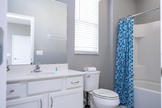 full bathroom with shower / bath combo, large vanity, and toilet