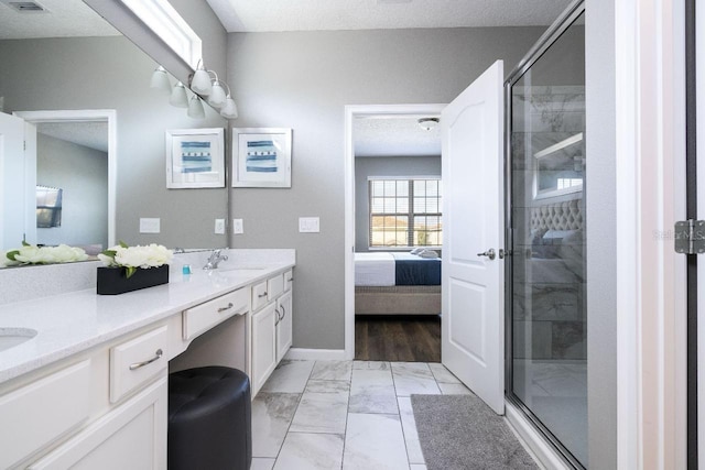 bathroom with a shower with shower door, dual vanity, a textured ceiling, and tile floors