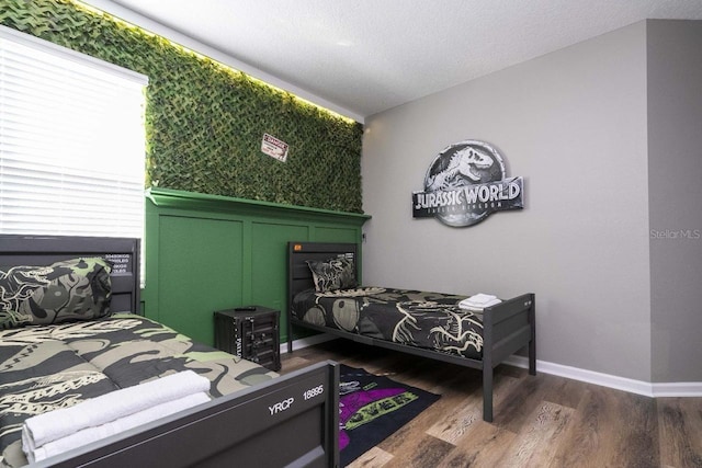 bedroom with hardwood / wood-style floors and a textured ceiling