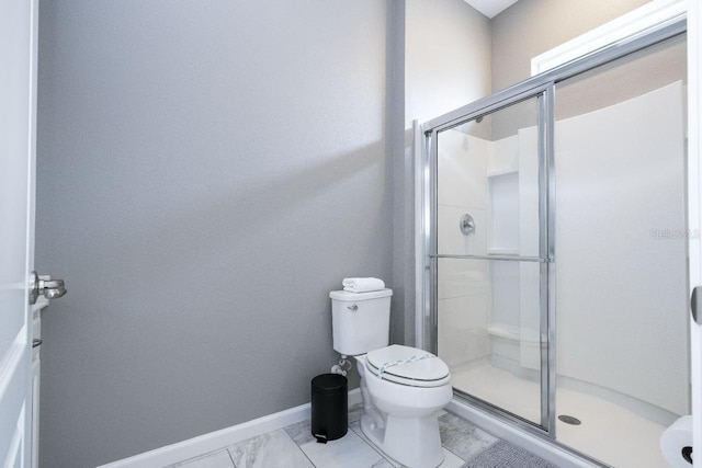 bathroom with tile flooring, a shower with shower door, and toilet