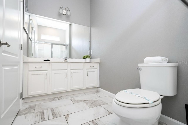 bathroom featuring tile flooring, vanity, and toilet