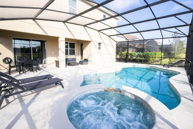 view of pool with a patio, glass enclosure, and an in ground hot tub