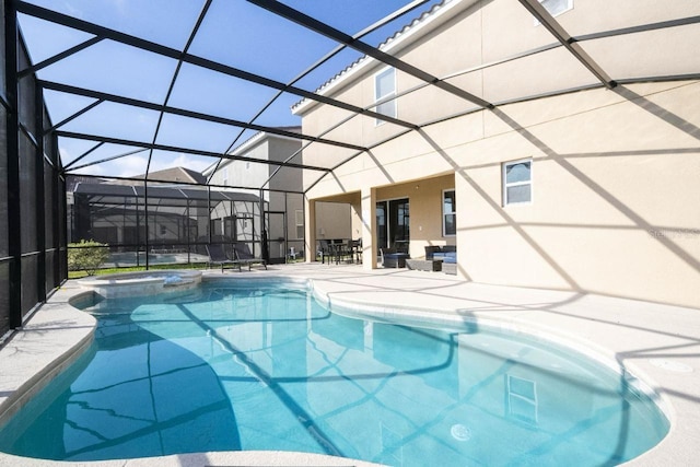 view of pool with glass enclosure, an in ground hot tub, and a patio