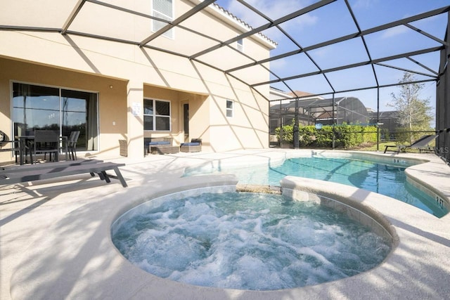 view of pool featuring a patio, a lanai, and an in ground hot tub