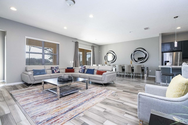 living room featuring french doors and light wood-type flooring