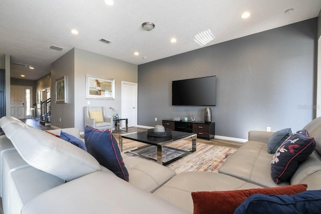 living room featuring a textured ceiling and hardwood / wood-style flooring