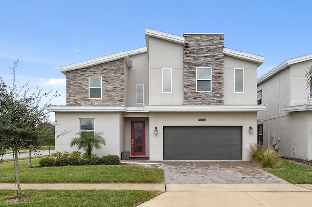 modern home featuring a garage and a front lawn