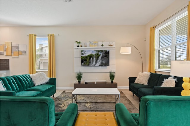 living room with light tile patterned floors and a wealth of natural light