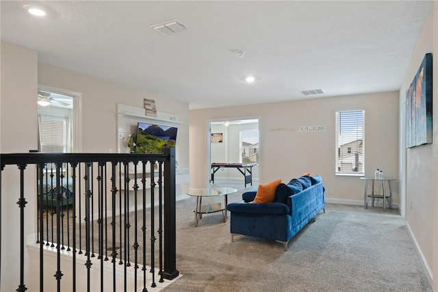 carpeted living room featuring ceiling fan