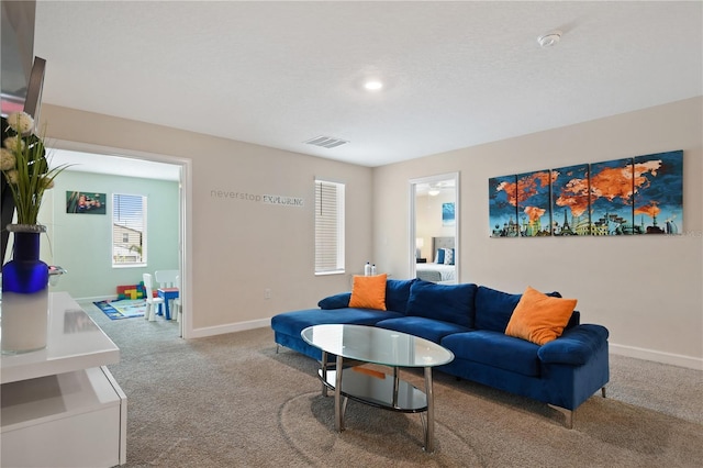 carpeted living room with ceiling fan