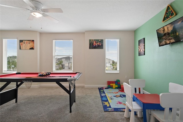 recreation room featuring billiards, ceiling fan, carpet floors, and a wealth of natural light