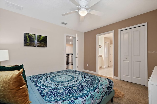 carpeted bedroom with connected bathroom, ceiling fan, and a closet