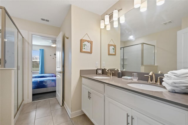 bathroom with tile patterned floors, ceiling fan, an enclosed shower, and vanity