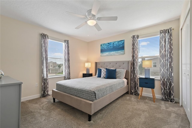 bedroom featuring ceiling fan, a closet, and light carpet