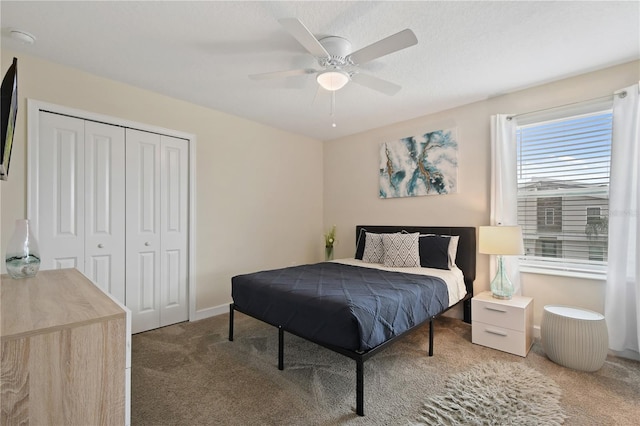 carpeted bedroom featuring ceiling fan and a closet