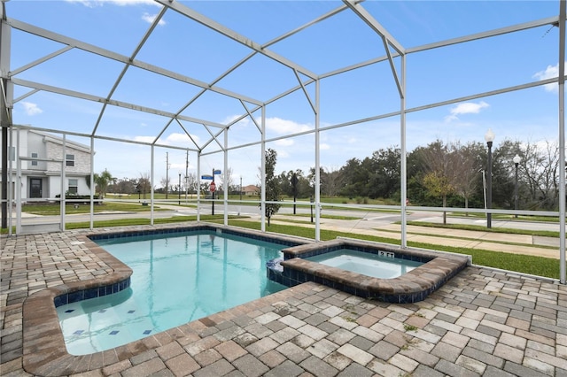 view of pool with glass enclosure, an in ground hot tub, and a patio