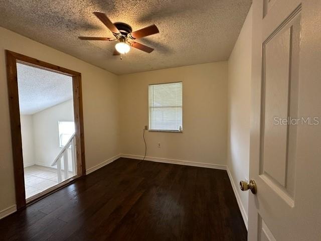 unfurnished room with wood-type flooring, ceiling fan, and a textured ceiling