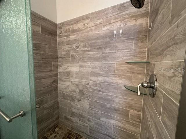 bathroom with a tile shower