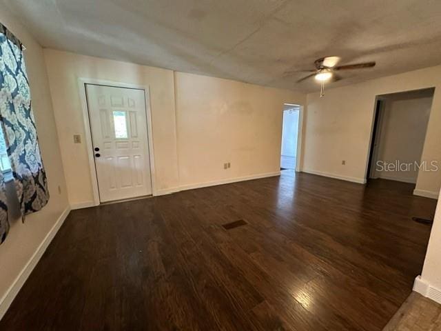 foyer with ceiling fan and dark hardwood / wood-style flooring