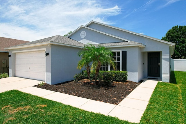 ranch-style home featuring a front yard and a garage