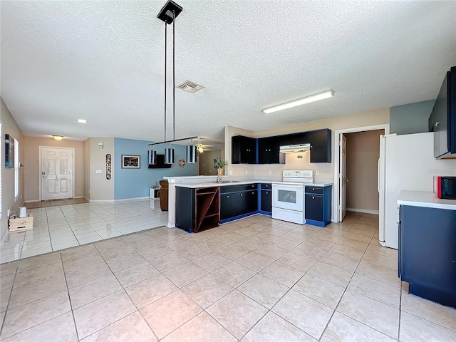 kitchen with light tile patterned floors, white appliances, decorative light fixtures, and kitchen peninsula