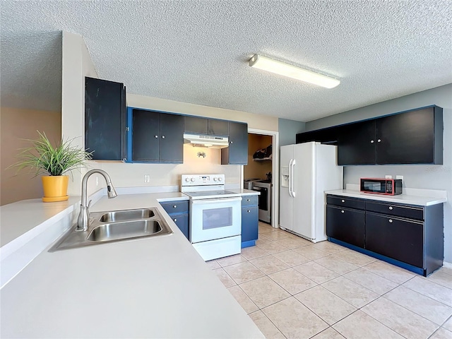 kitchen featuring sink, white appliances, light tile patterned floors, and a textured ceiling