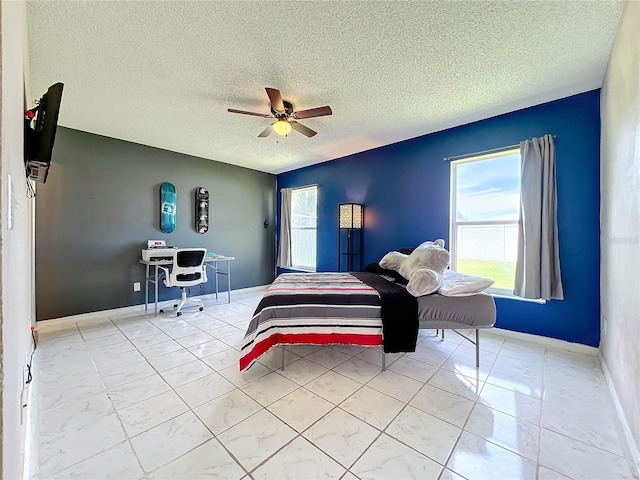 bedroom with a textured ceiling and ceiling fan